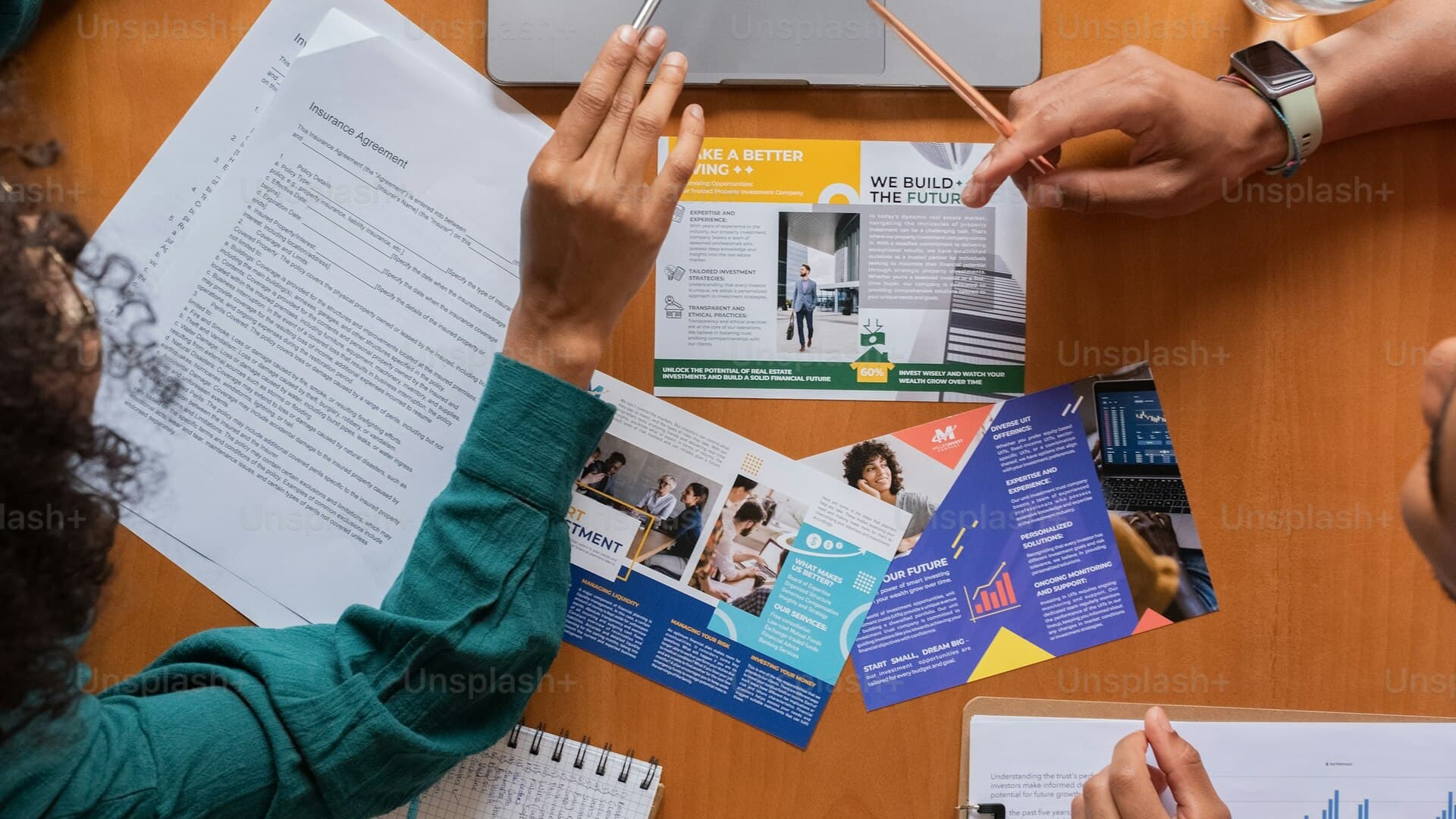Financial strategist reviewing charts beside a glowing green desk lamp